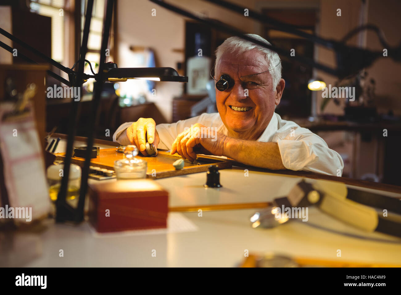 Horologist repairing a watch in the Stock Photo Alamy