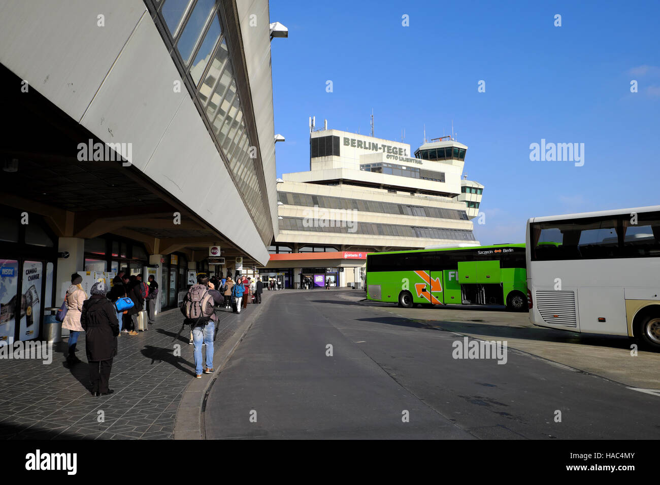 People travelers walking and buses parked at Berlin Tegel Airport in Berlin Germany Europe EU  KATHY DEWITT Stock Photo