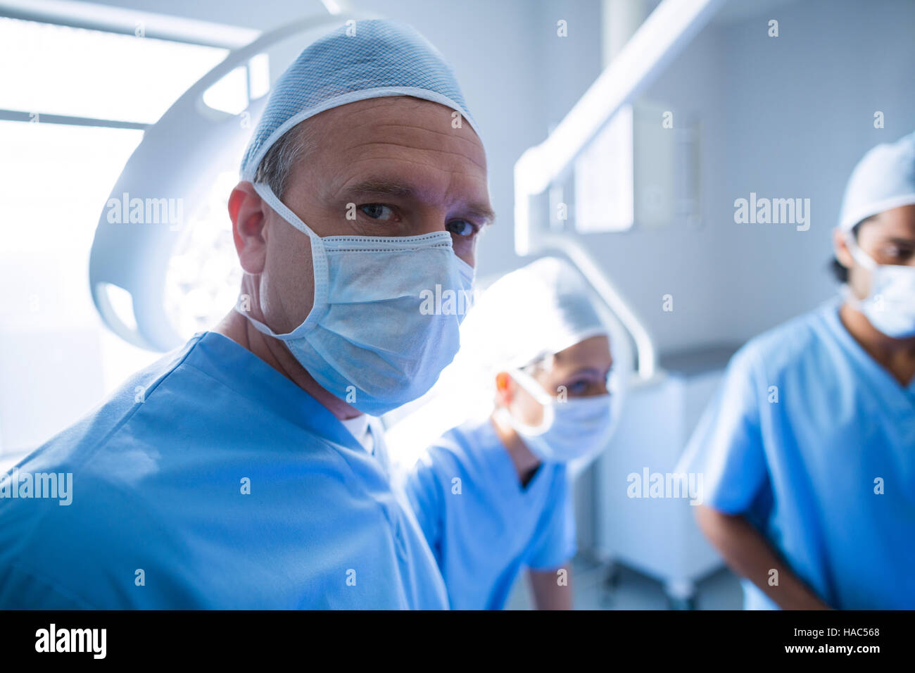 Surgeon looking at camera in operation room Stock Photo - Alamy