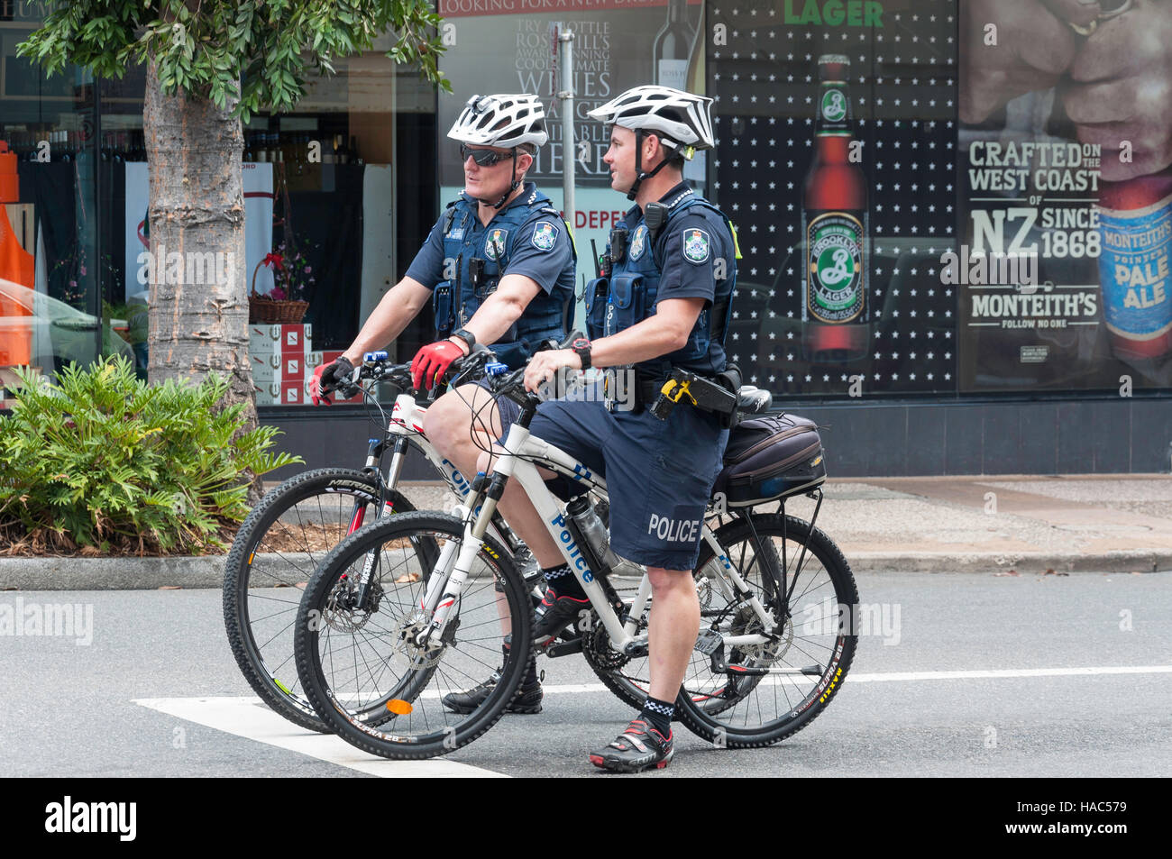 Policemen patrolling on bicycles, Wickham Street, Fortitude Valley, Brisbane, Queensland, Australia Stock Photo