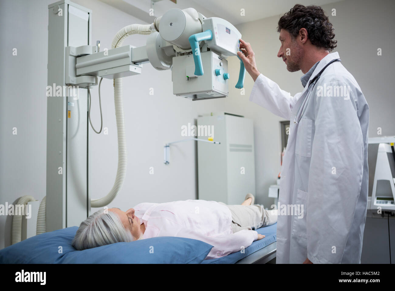 Doctor performing a xray test on patient chest Stock Photo Alamy