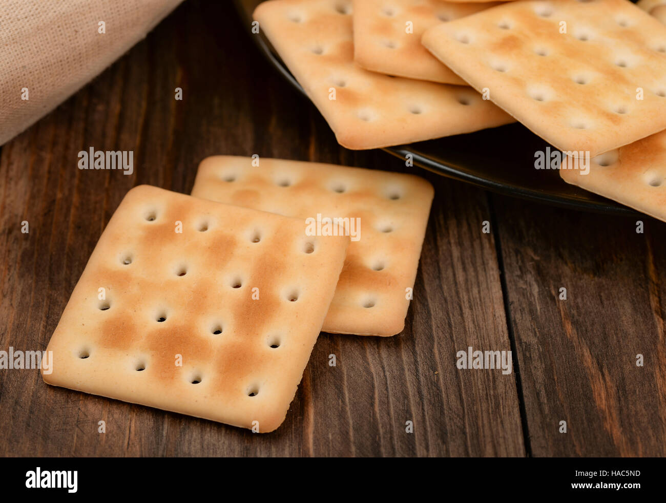 Saltine crackers on dark wooden table Stock Photo
