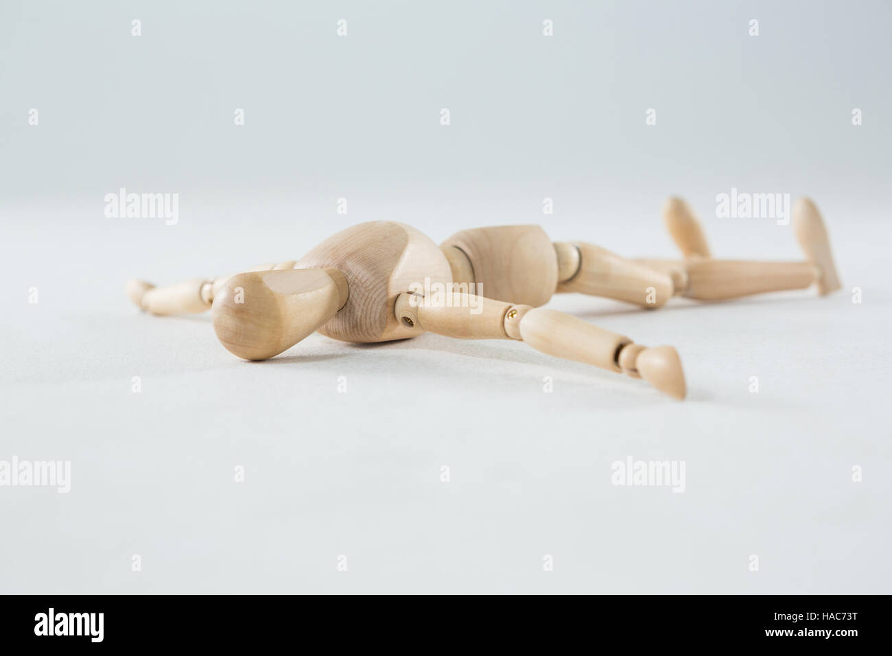 Lying Objects Wooden figurine lying on floor Stock Photo - Alamy