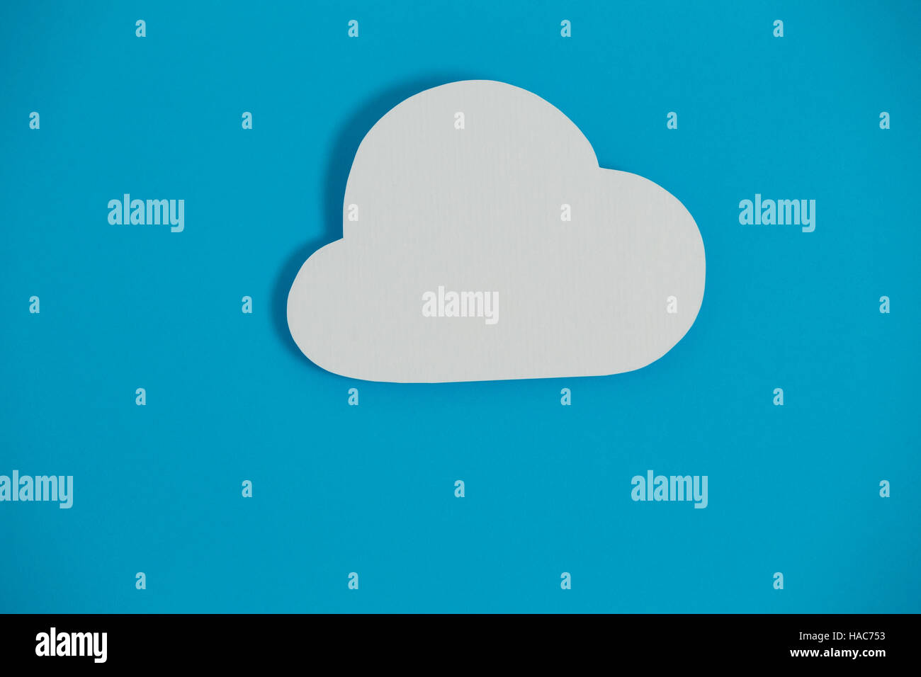 Cloud paper on blue background Stock Photo - Alamy