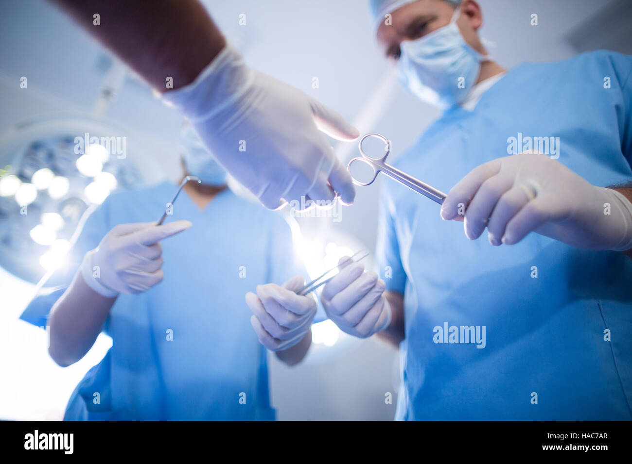 Group of surgeons performing operation in operation room Stock Photo ...