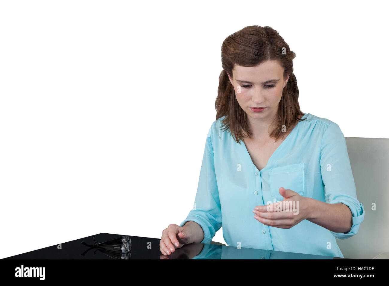 Businesswoman sitting at desk and using digital screen Stock Photo