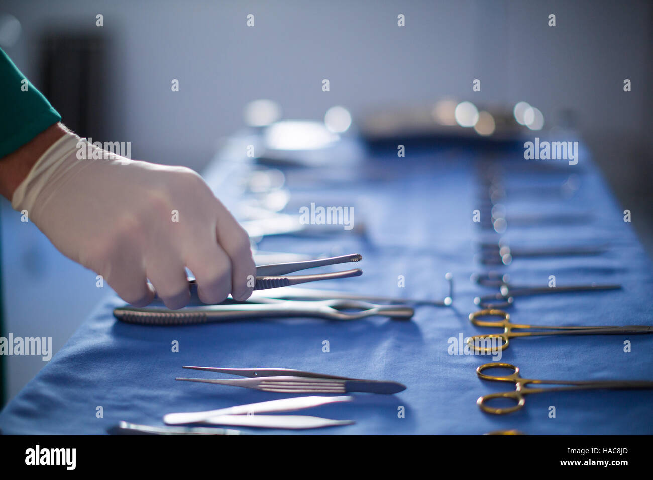 Surgeon holding surgical tool in operation theater Stock Photo Alamy