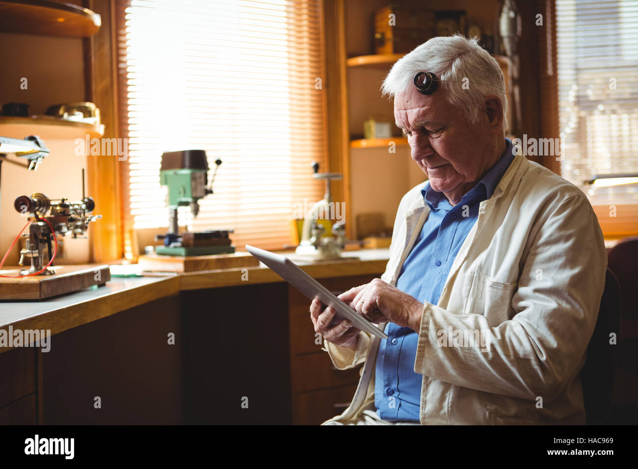 Horologist using digital tablet Stock Photo Alamy