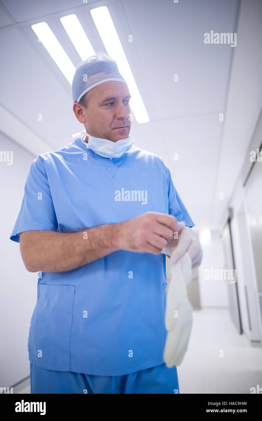 Surgeon wearing surgical gloves Stock Photo Alamy