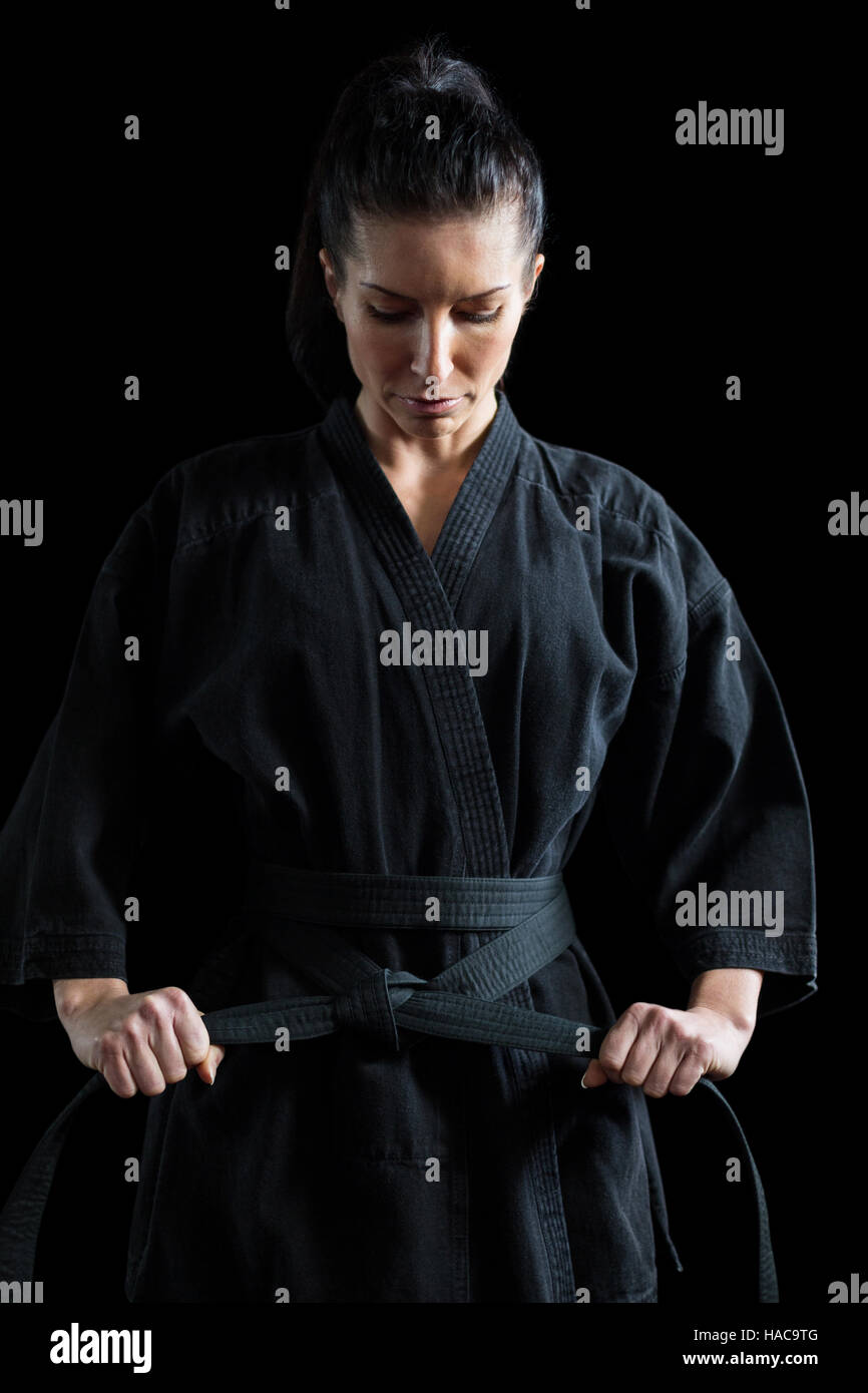 Confident karate player holding his belt Stock Photo