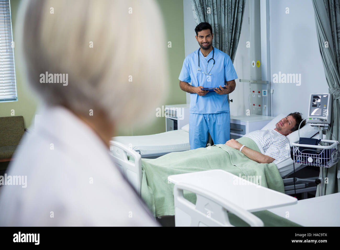 Doctor and surgeon interacting in ward Stock Photo - Alamy