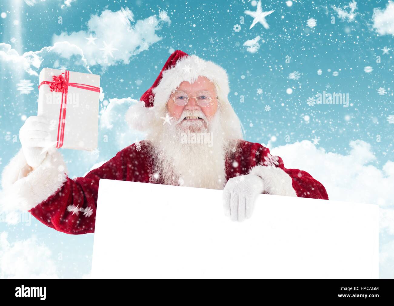 Santa claus holding a gift and blank placard Stock Photo