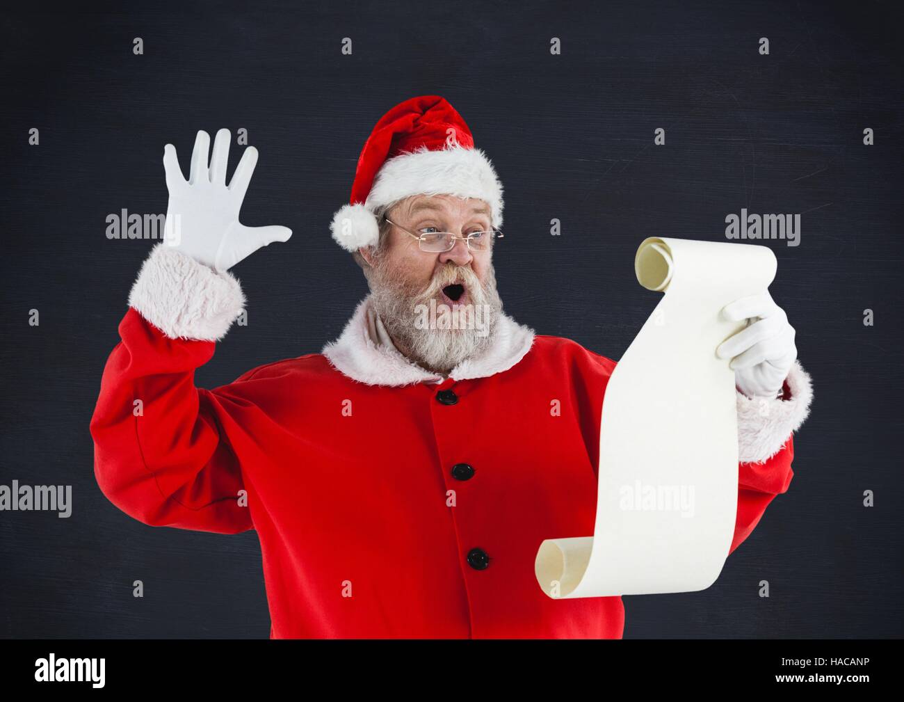 Santa claus reading a wish list Stock Photo - Alamy