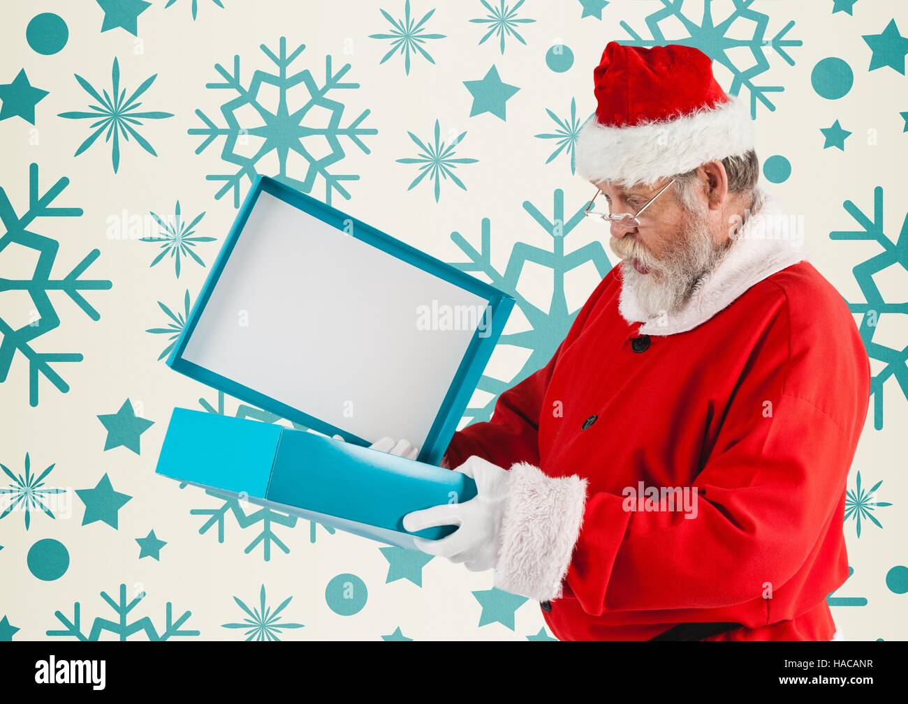 Surprised santa claus opening his christmas gift Stock Photo