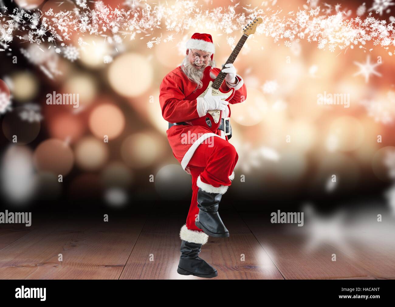 Santa claus playing electric guitar on wooden plank Stock Photo