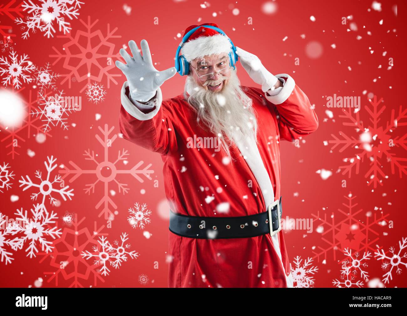 Happy santa claus listening to music on headphones Stock Photo