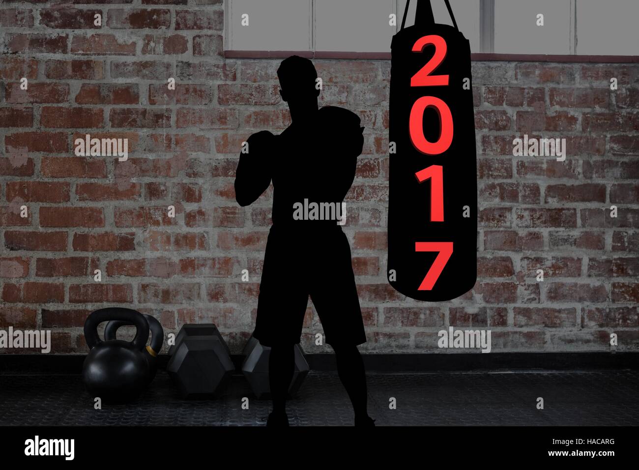 Composite image of 2017 on punching bag and silhouette of boxer Stock Photo