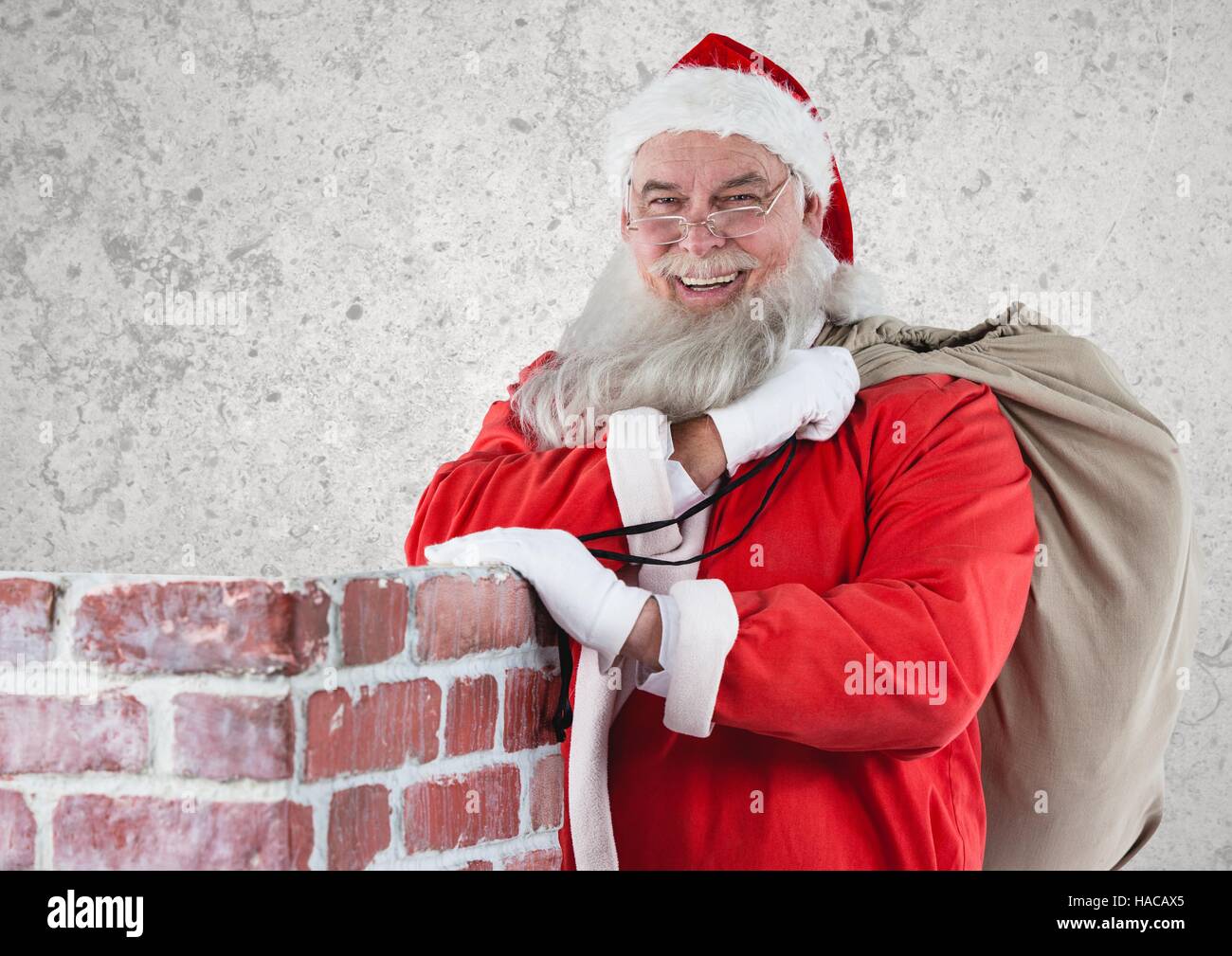 Cheerful santa claus carrying gift bag Stock Photo - Alamy