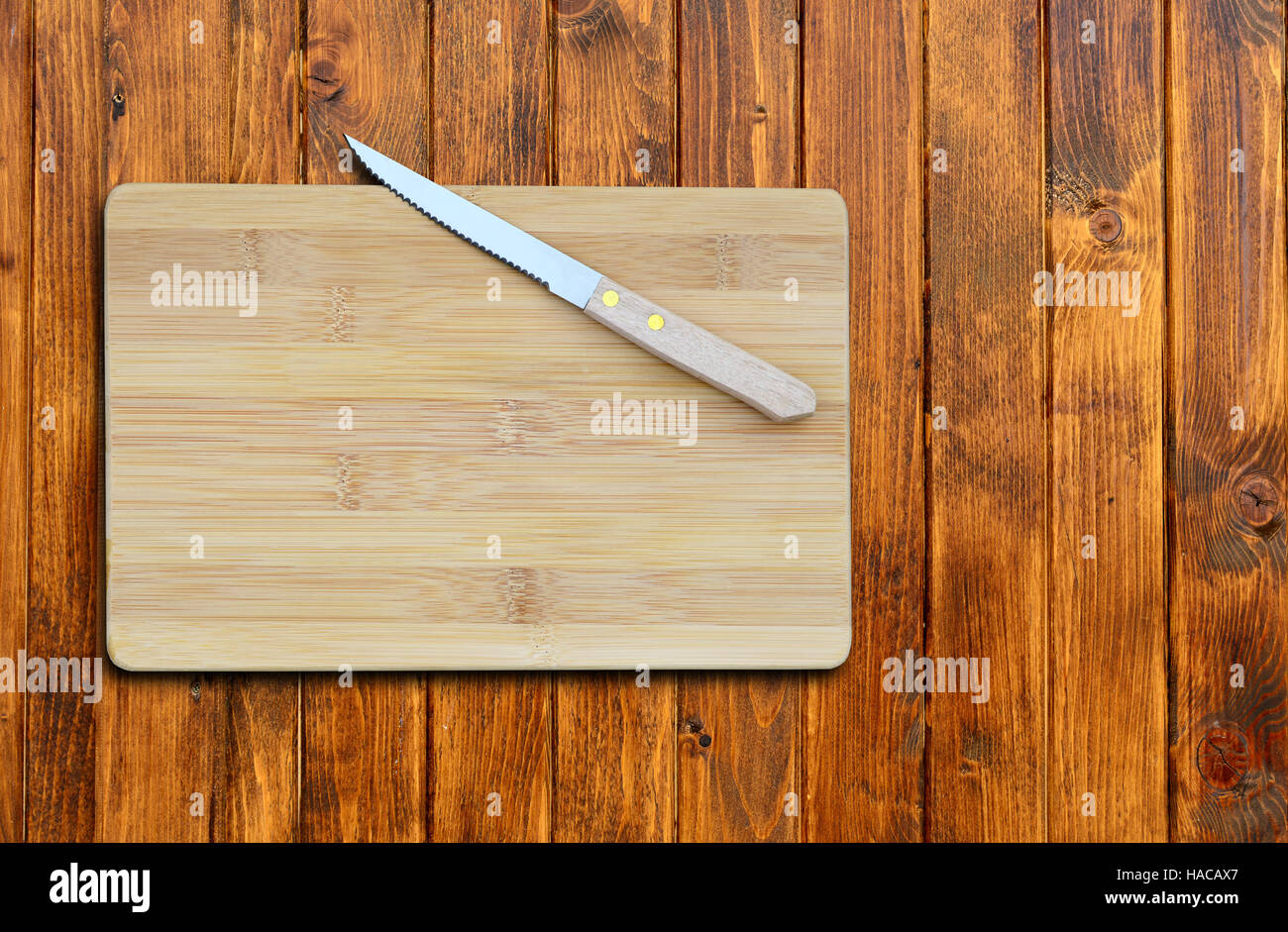 https://c8.alamy.com/comp/HACAX7/empty-bamboo-cutting-board-and-knife-on-a-old-wooden-table-for-product-HACAX7.jpg