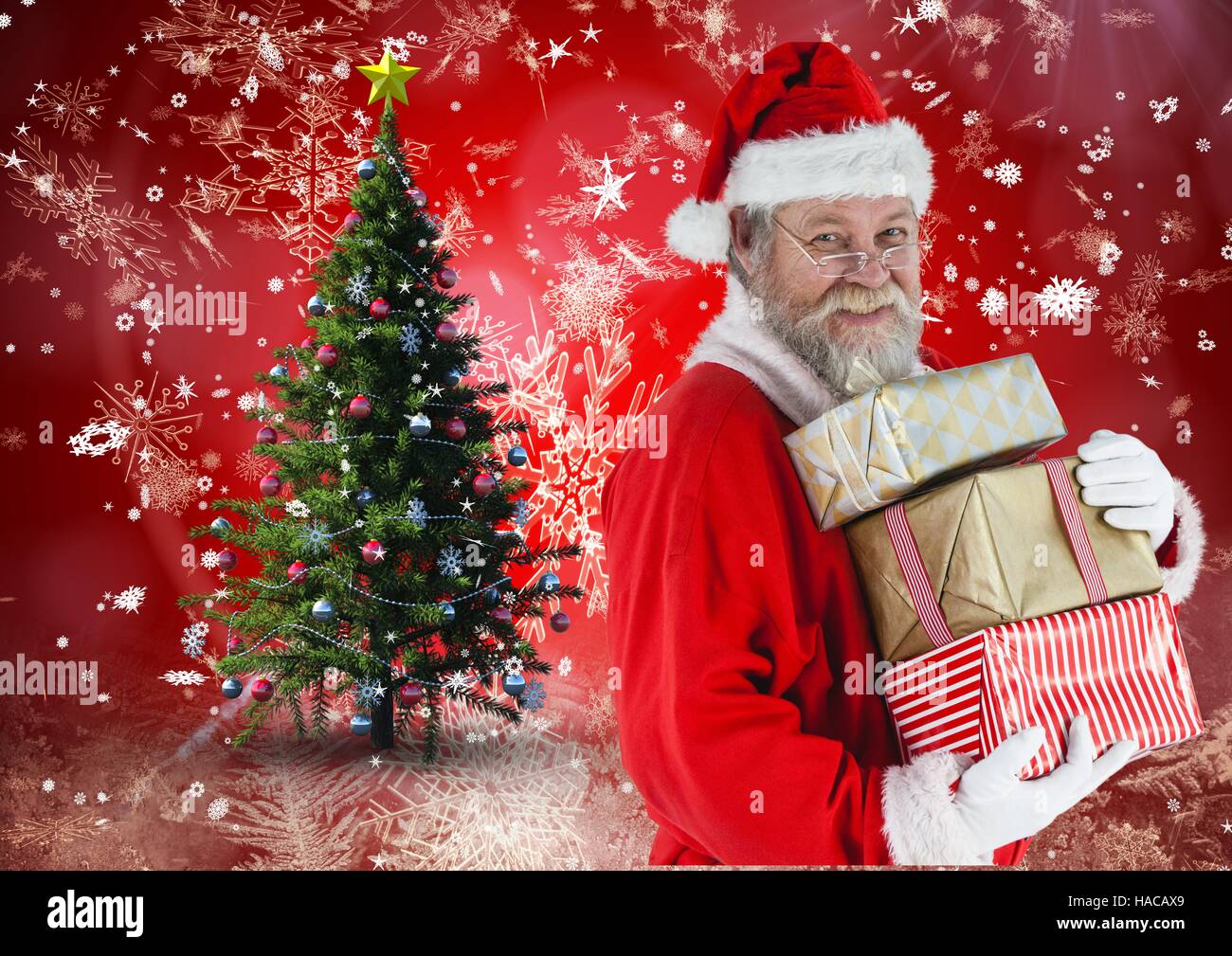 Happy santa claus holding stack of gifts Stock Photo