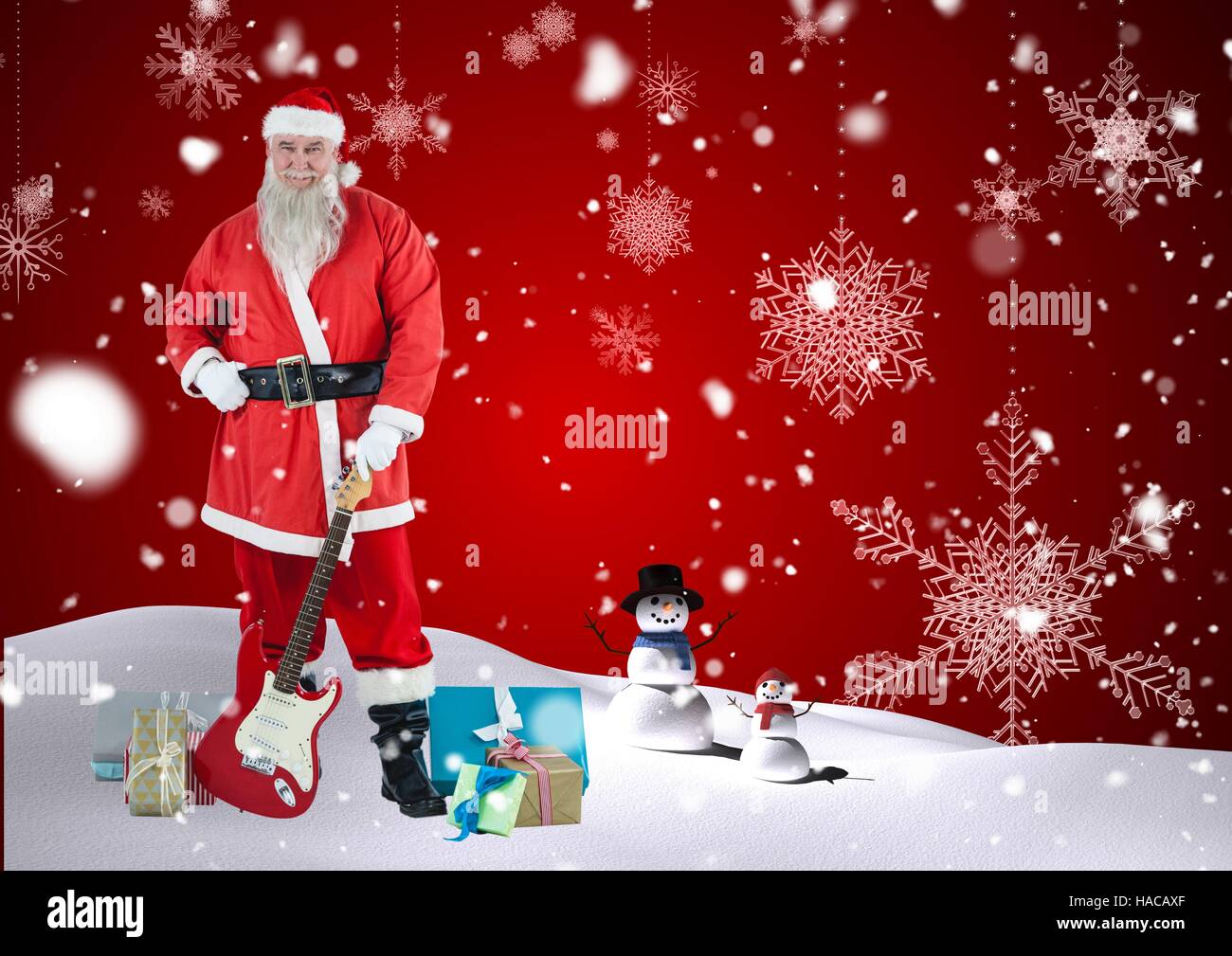 Santa claus holding guitar in snow Stock Photo