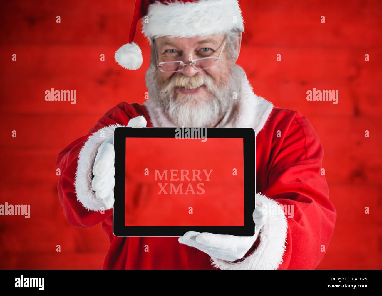 Santa claus holding a digital tablet Stock Photo