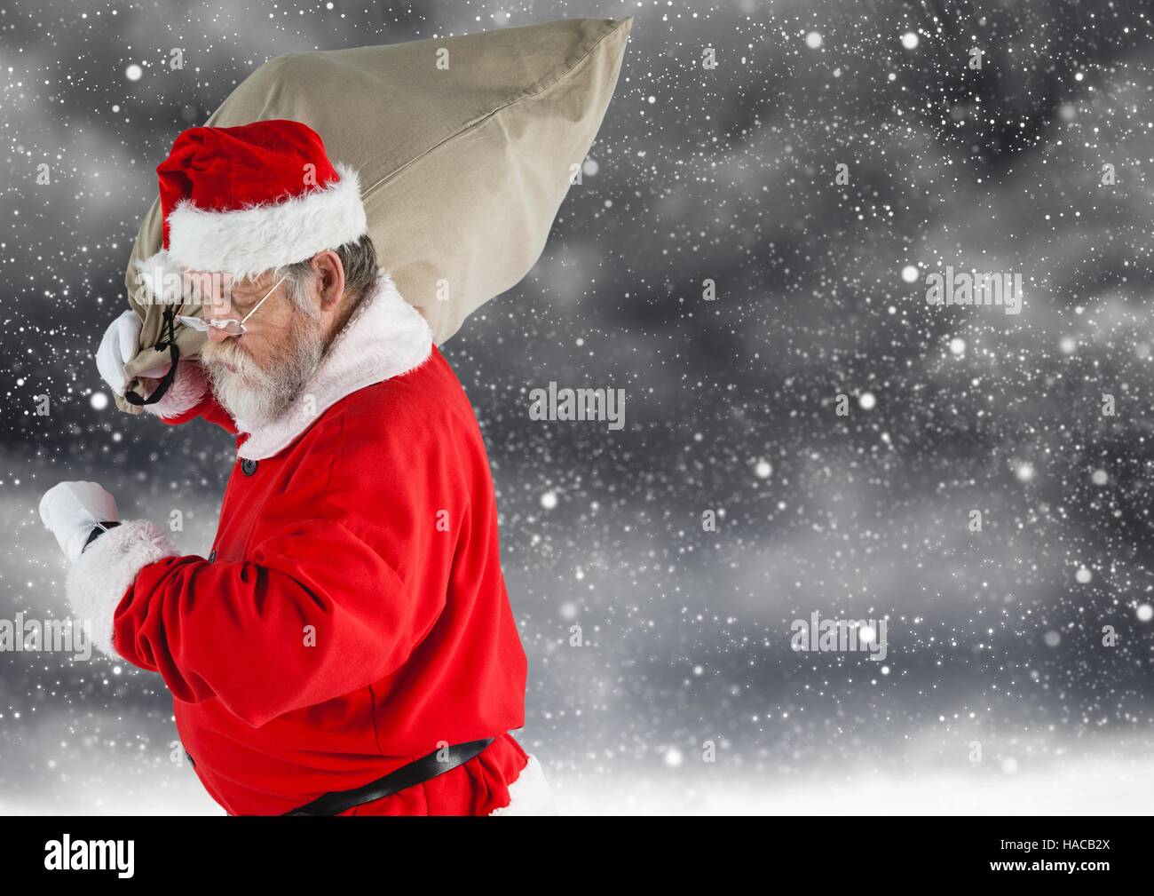 Santa claus carrying gift bag Stock Photo - Alamy