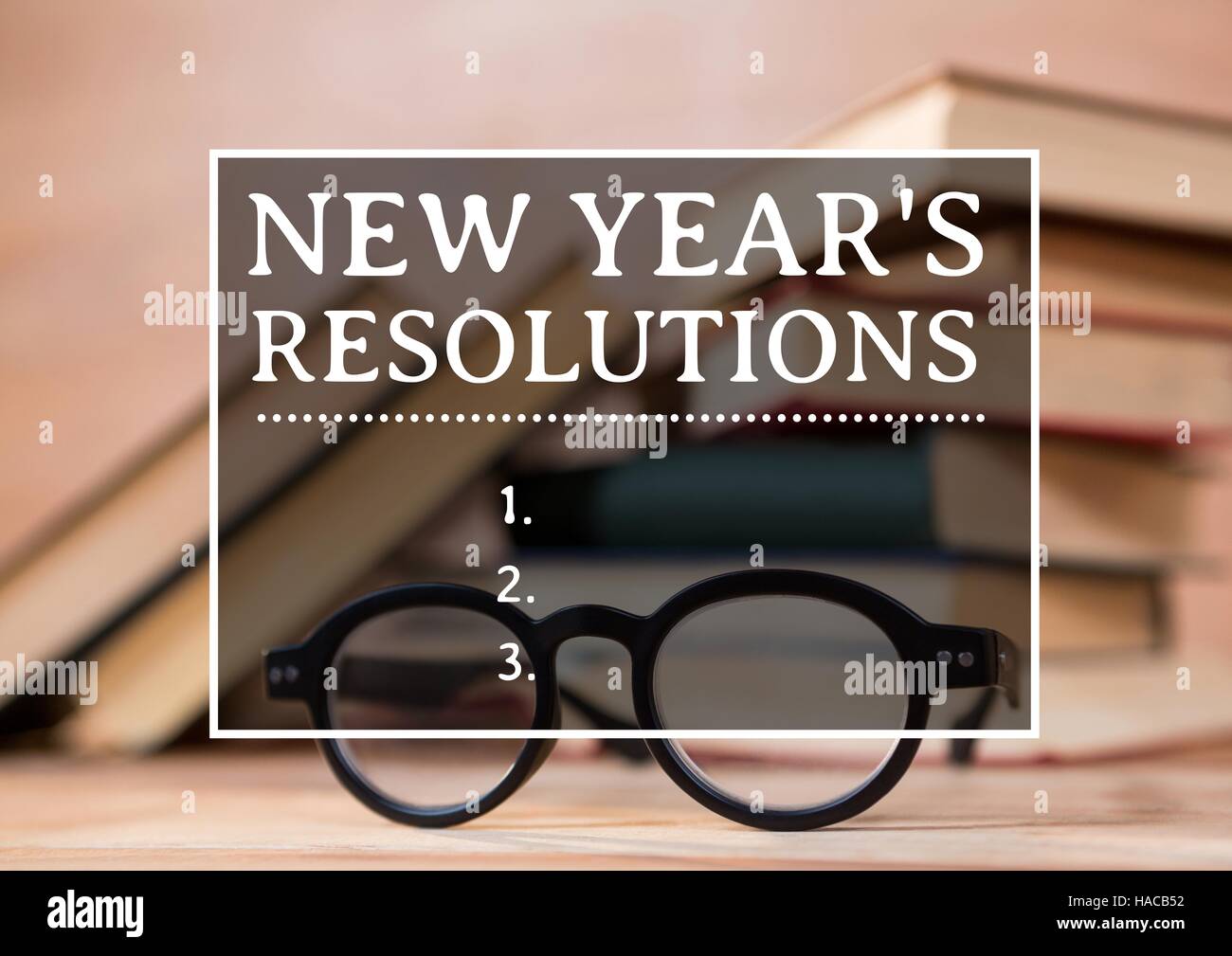 New year resolution goals against books and spectacles Stock Photo