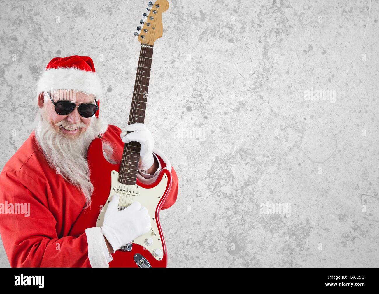 Santa claus wearing sunglasses playing guitar Stock Photo