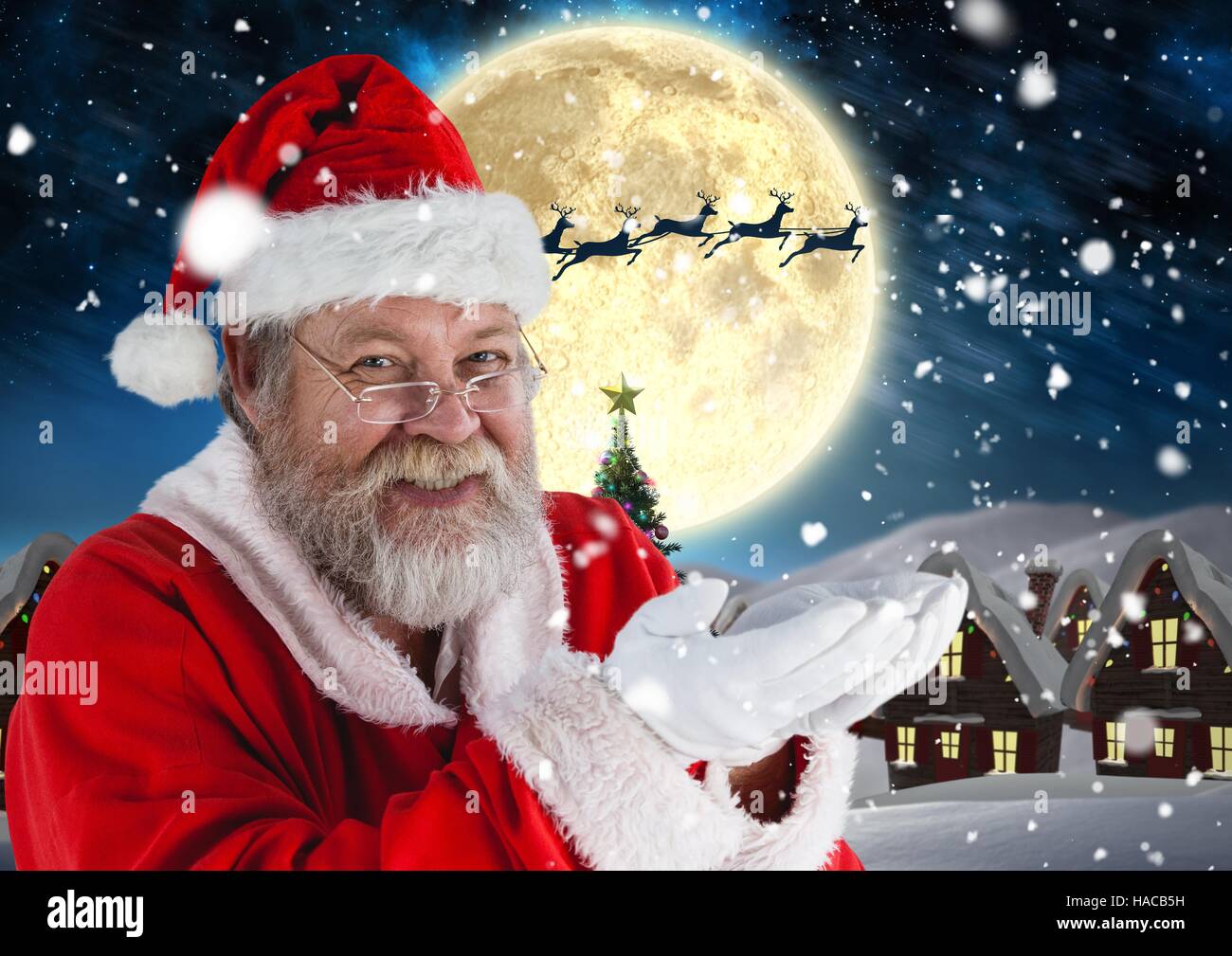 Santa pretending to hold digital generated snow Stock Photo