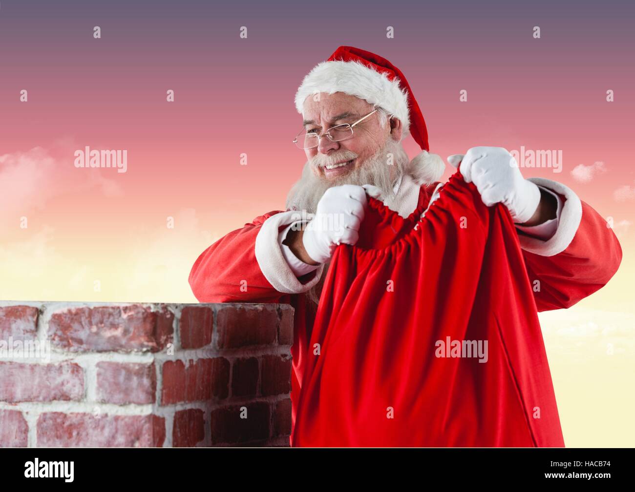 Santa claus carrying gift bag Stock Photo - Alamy
