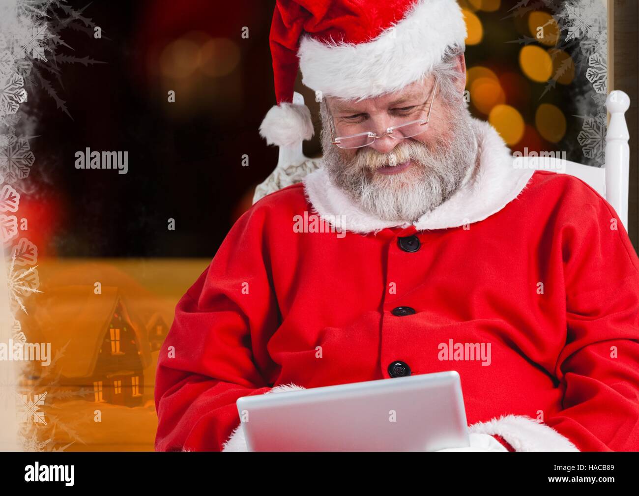 Santa claus using digital tablet Stock Photo