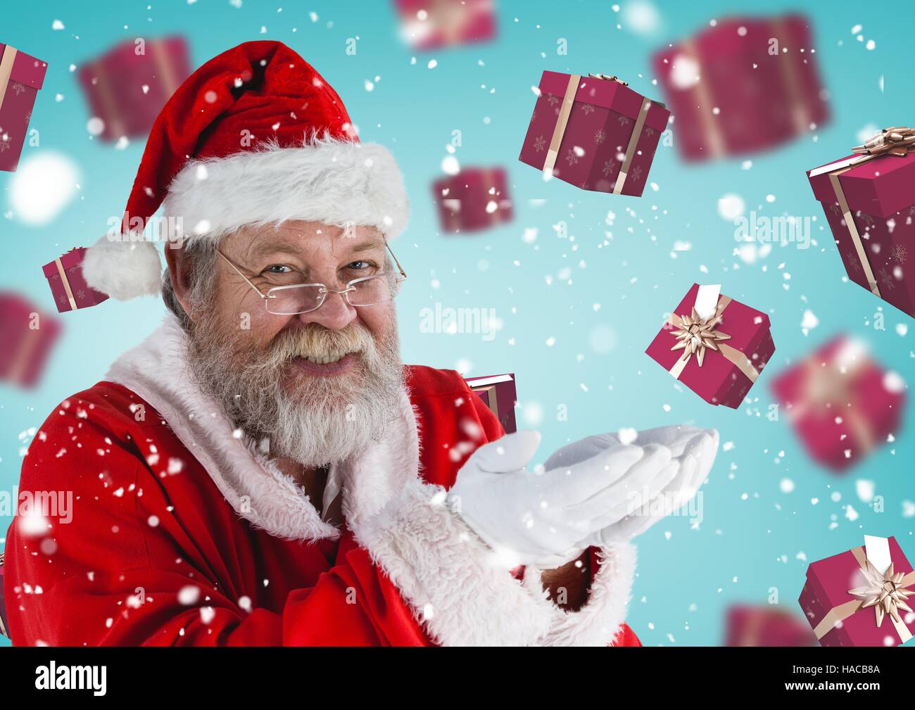 Santa pretending to hold digital generated christmas gifts Stock Photo