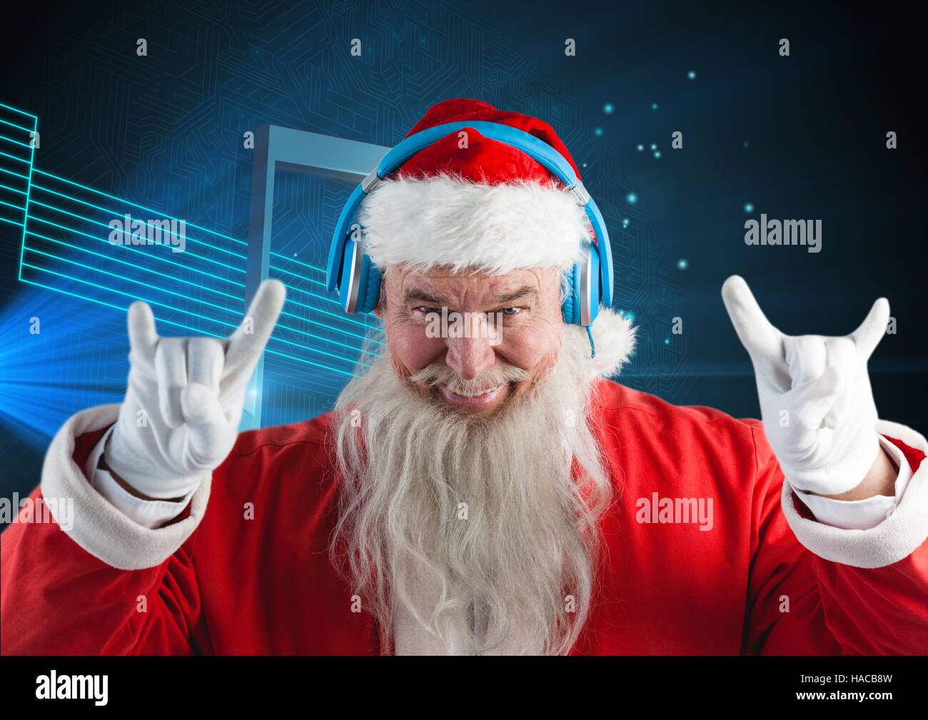 Santa claus listening to music on headphones Stock Photo