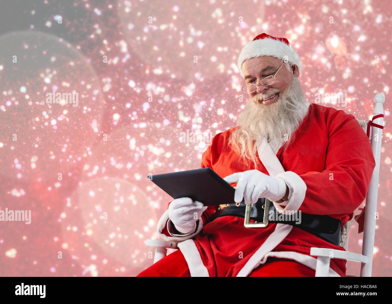 Santa claus using a digital tablet Stock Photo - Alamy