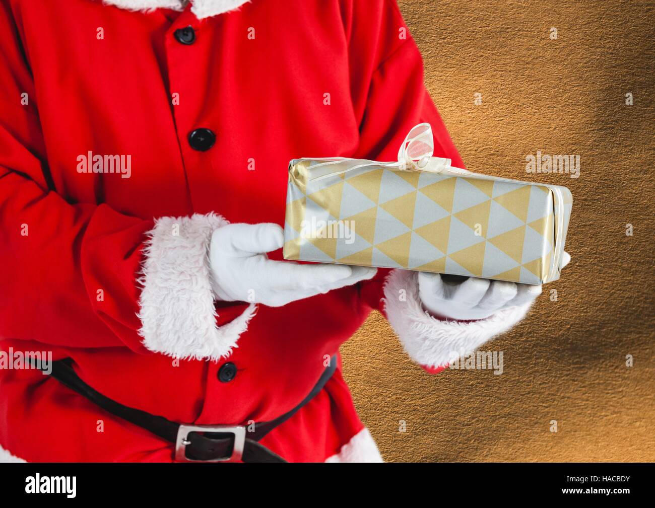Mid section of Santa Claus holding a gift box Stock Photo