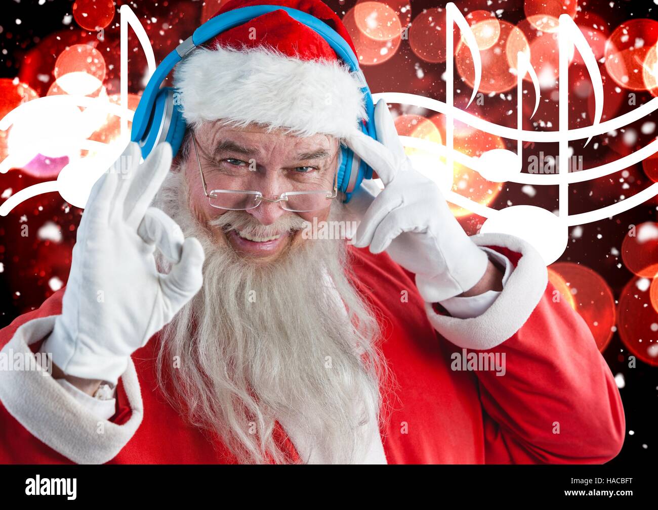 Santa claus listening to music headphones Stock Photo