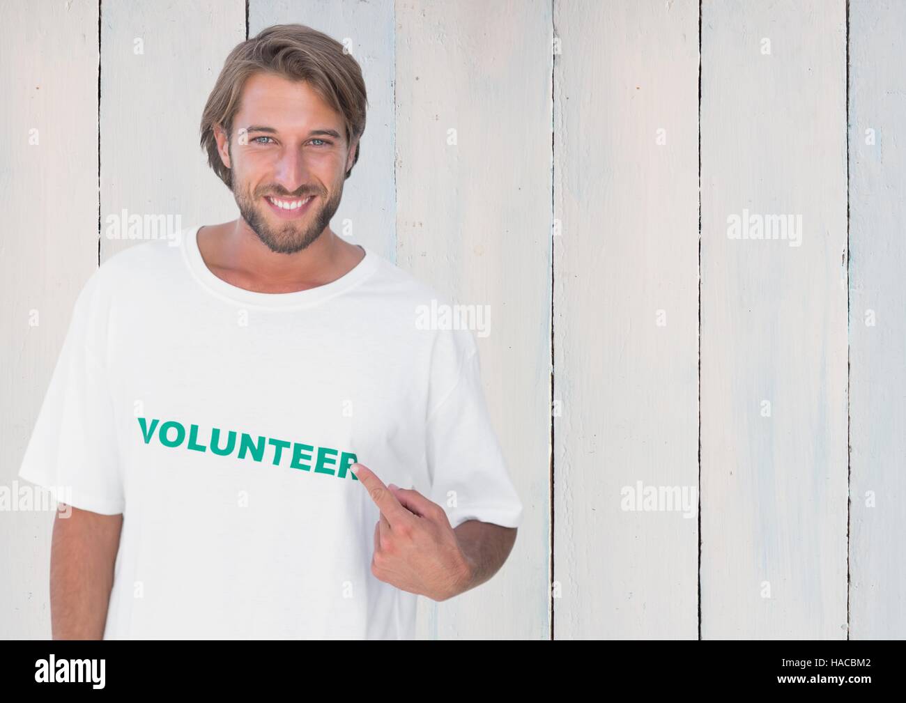 Smiling man pointing at message printed on their tshirt Stock Photo