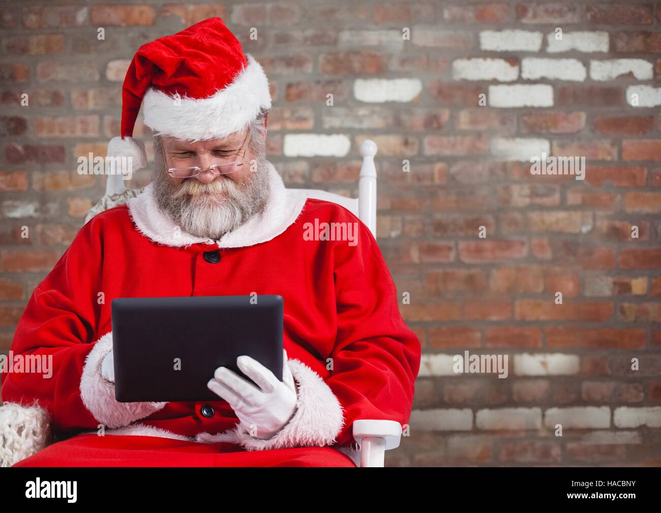 Santa claus using a digital tablet Stock Photo