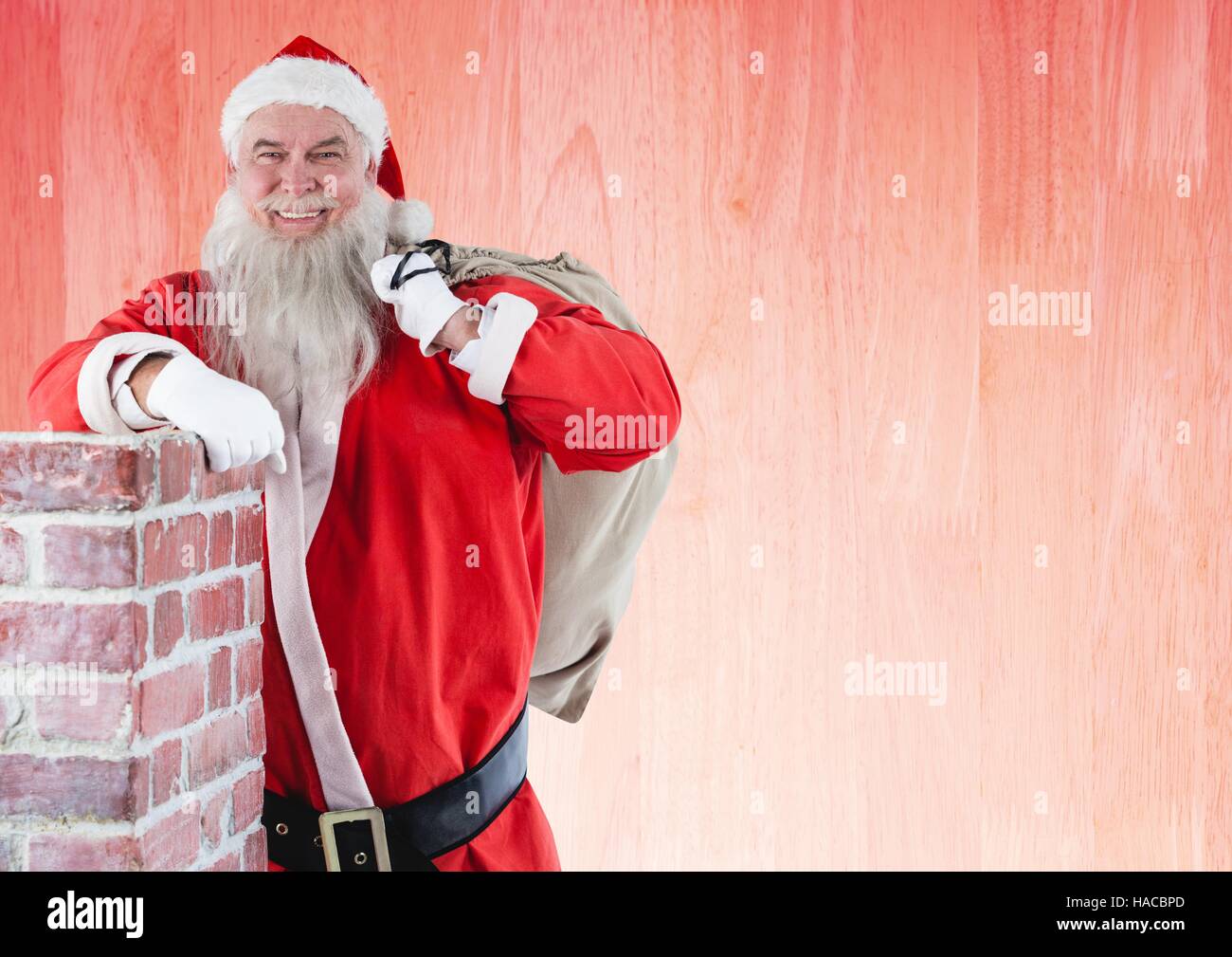 Cheerful Santa claus carrying gift bag Stock Photo - Alamy