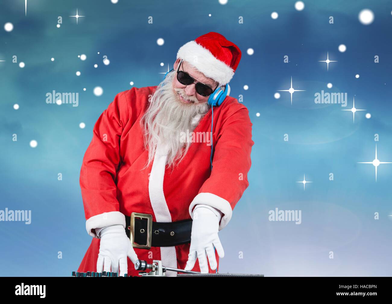 Santa in sunglasses playing dj Stock Photo