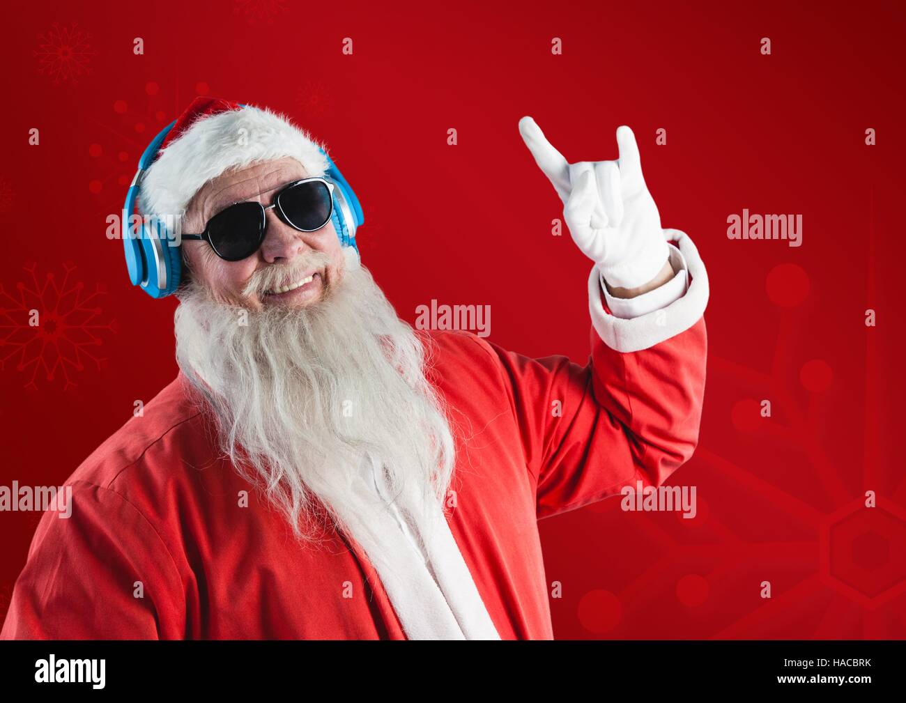 Santa claus listening music on headphones and gesturing Stock Photo
