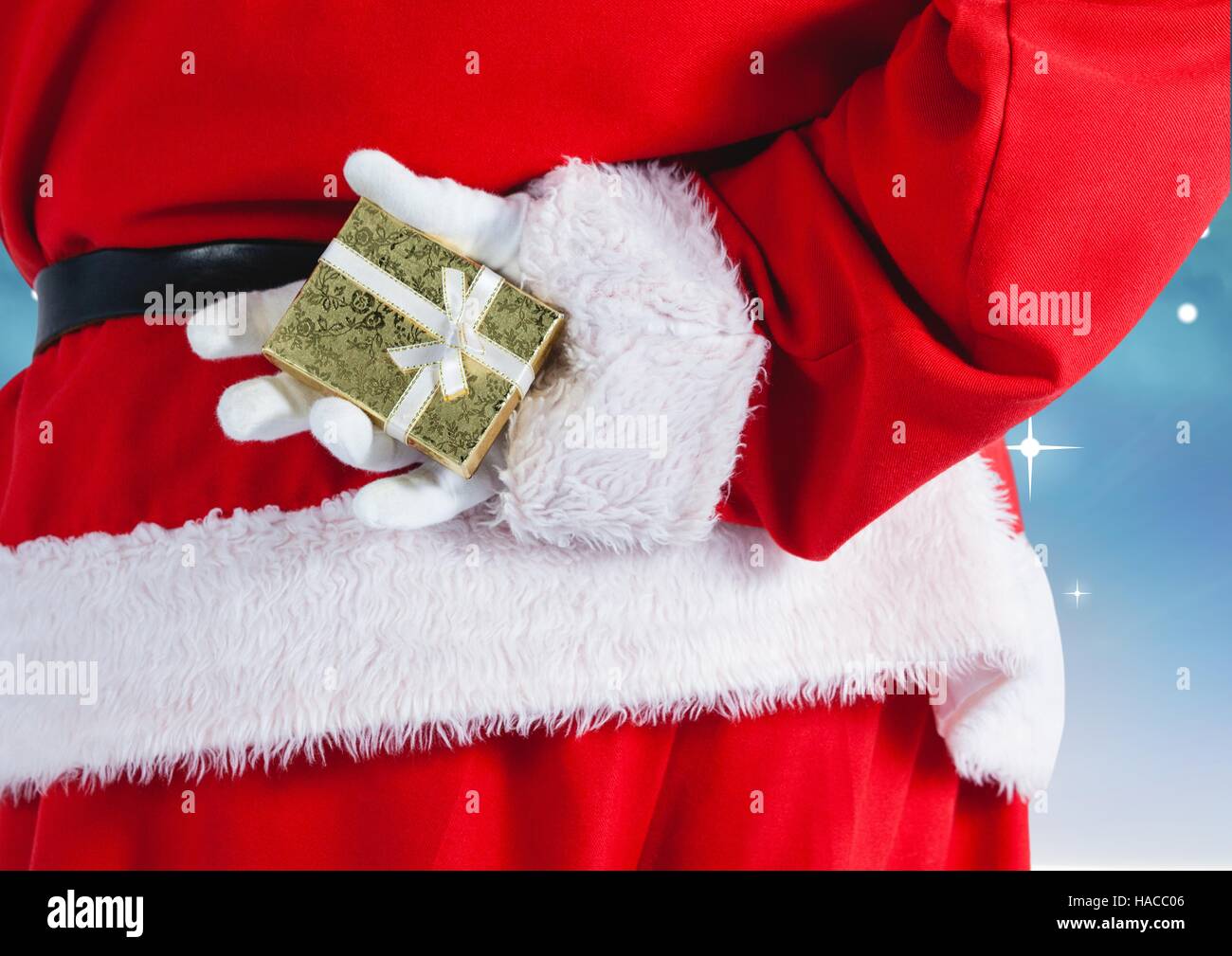 Santa claus hiding gift behind his back Stock Photo