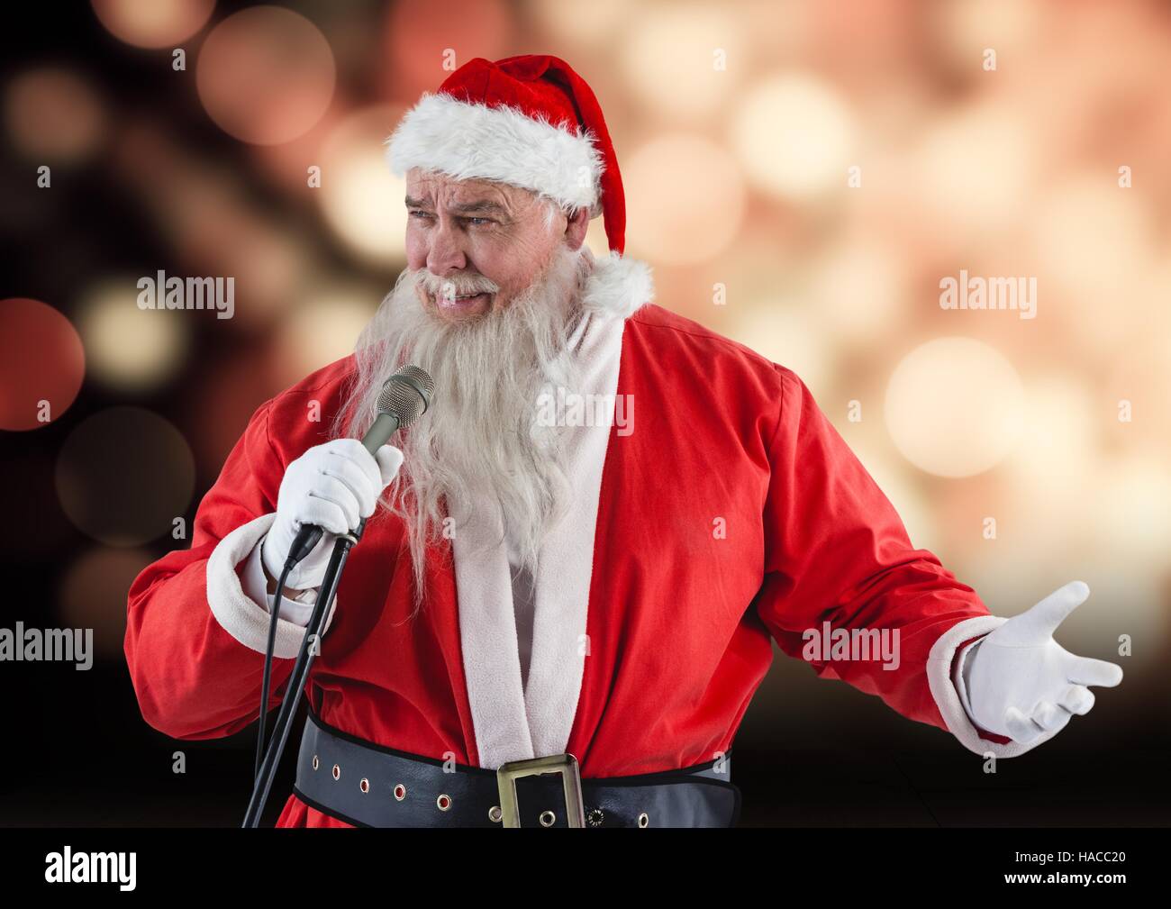 Santa claus with a microphone singing christmas songs Stock Photo