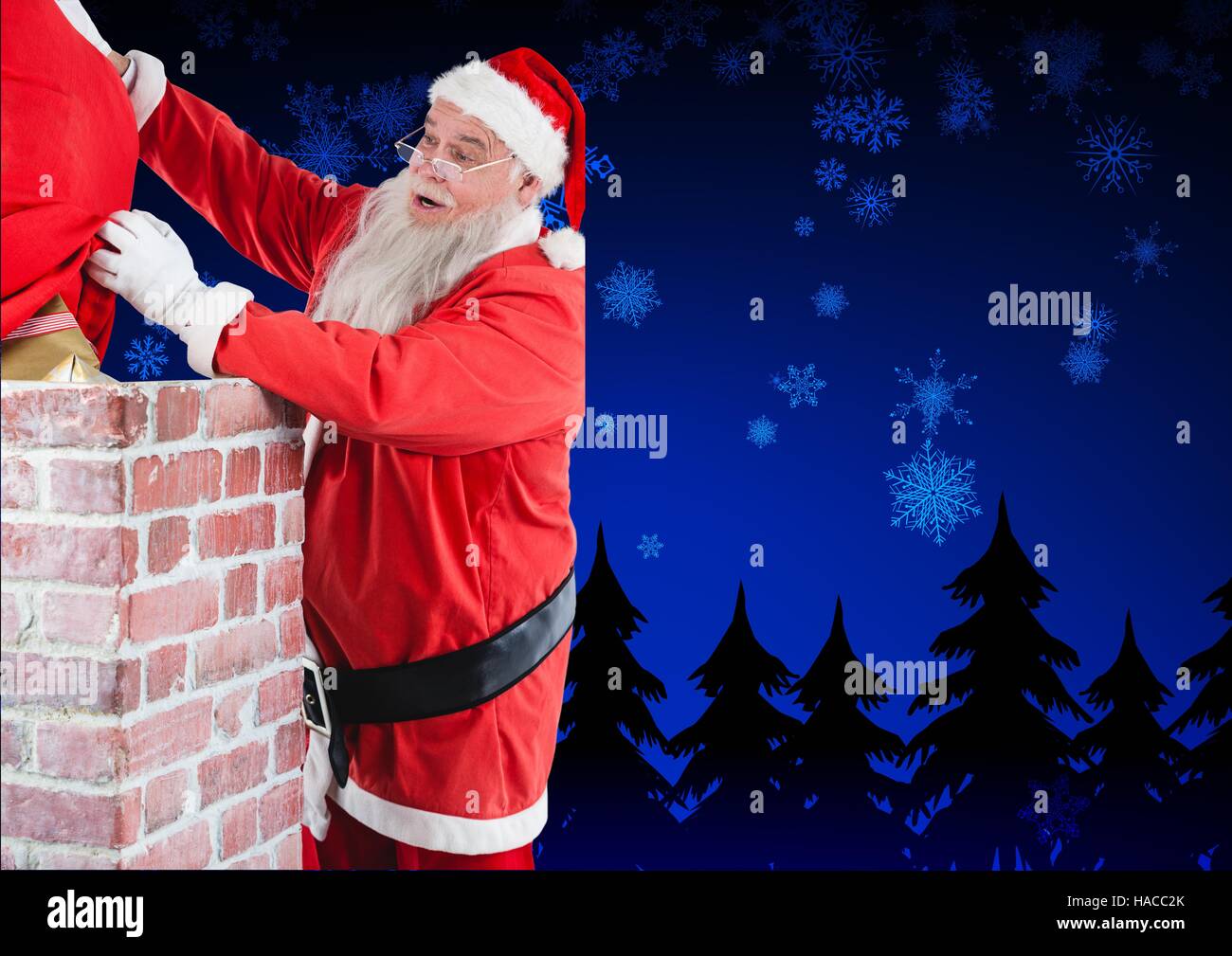 Santa claus placing his gift sack into the chimney Stock Photo