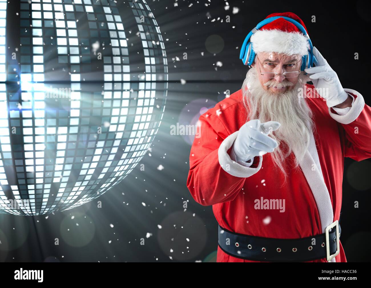 Santa gesturing while listening music on headphones Stock Photo