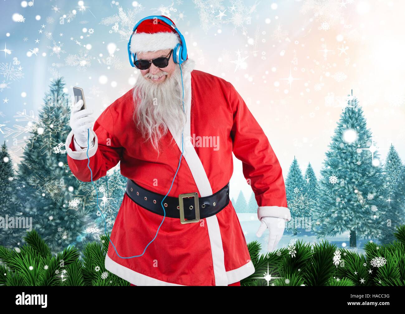 Santa in sunglasses listening music on mobile phone Stock Photo