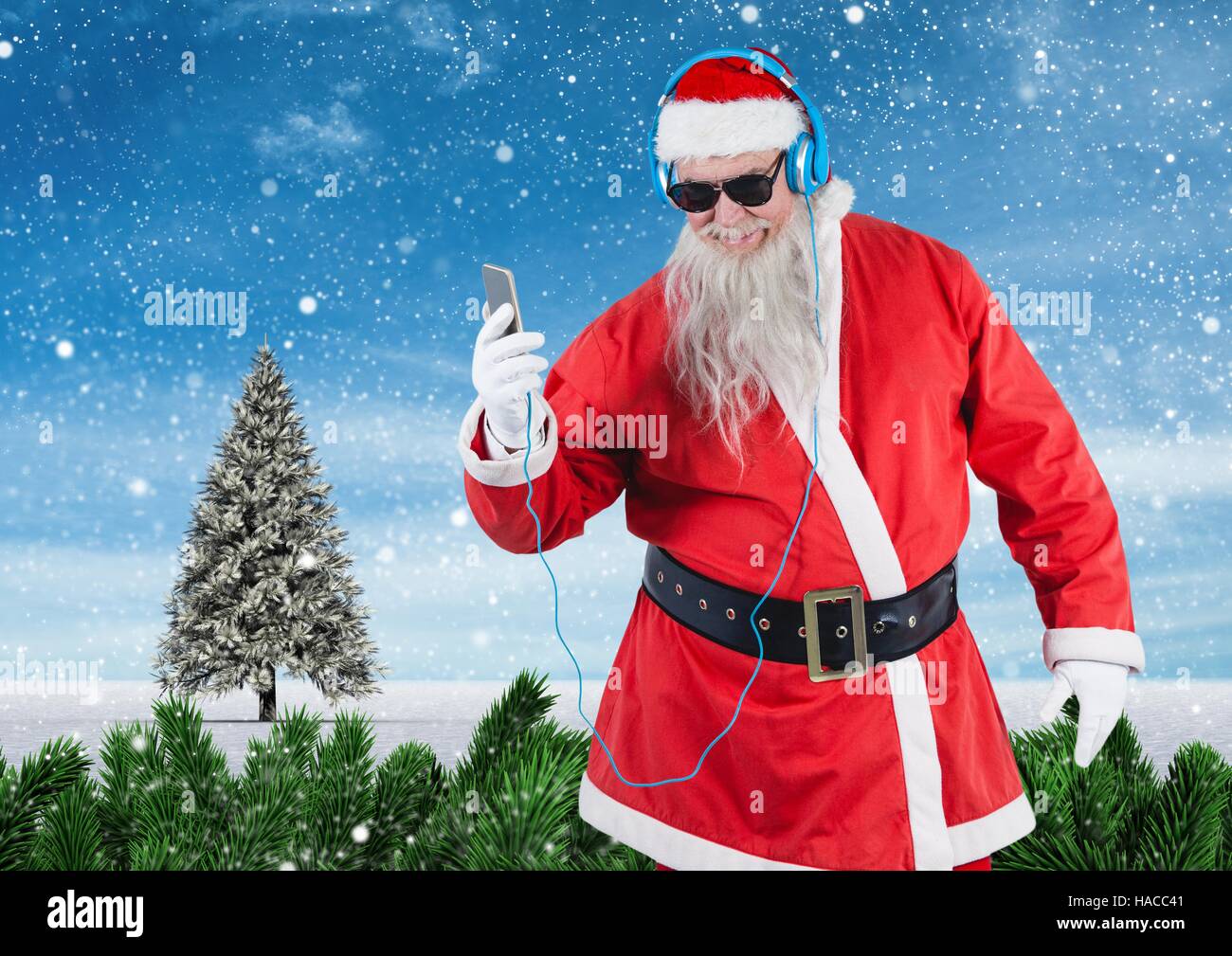 Santa in sunglasses listening music on mobile phone Stock Photo