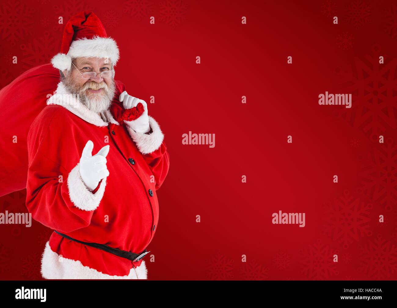 Santa claus carrying gift bag Stock Photo - Alamy