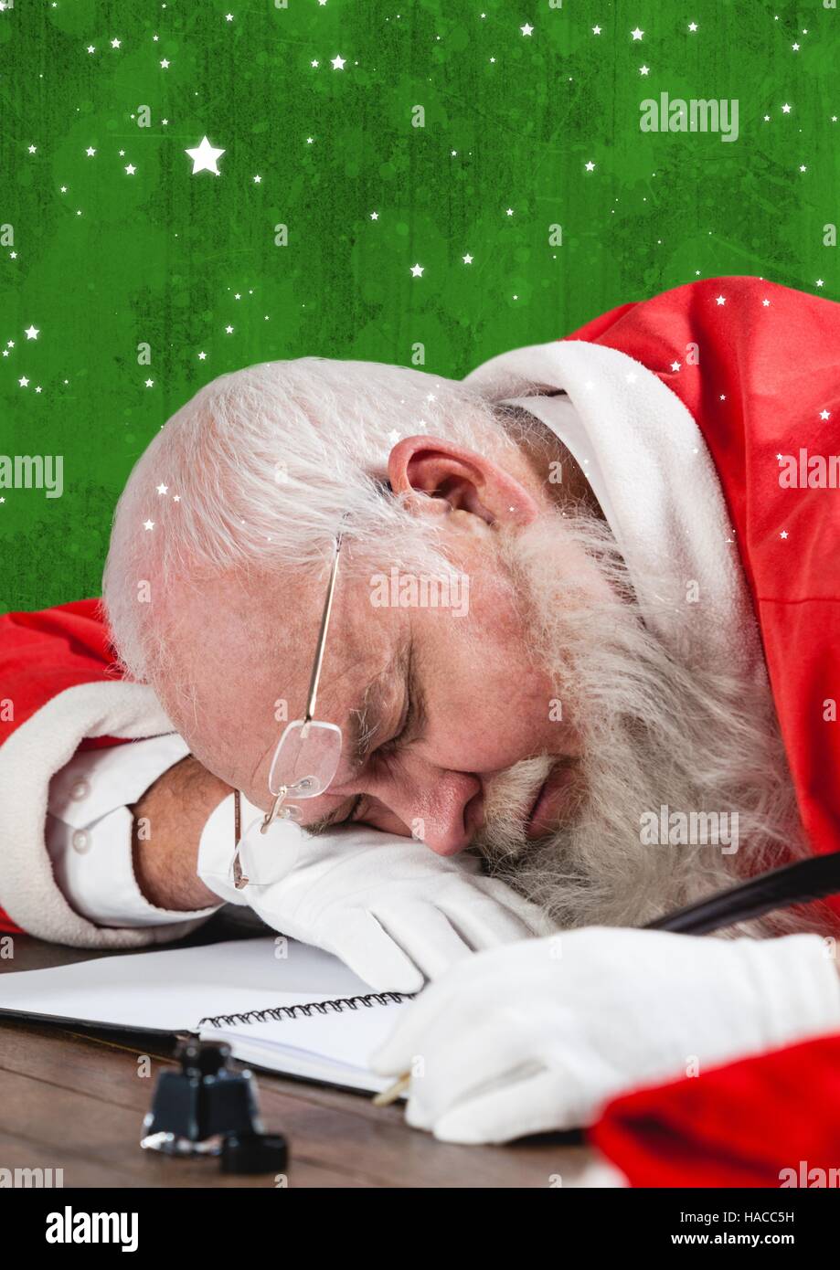 Tired santa claus sleeping at table Stock Photo